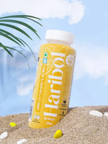 I created a fun, beachy vibe for this vanilla flavored milk. The product is placed in the sand against a sky backdrop, evoking a sense of a holiday treat or a refreshing beach drink.