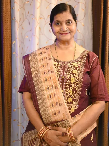 A graceful portrait of a woman dressed in a beautiful embroidered salwar kameez for Karwa Chauth, showcasing her festive look.