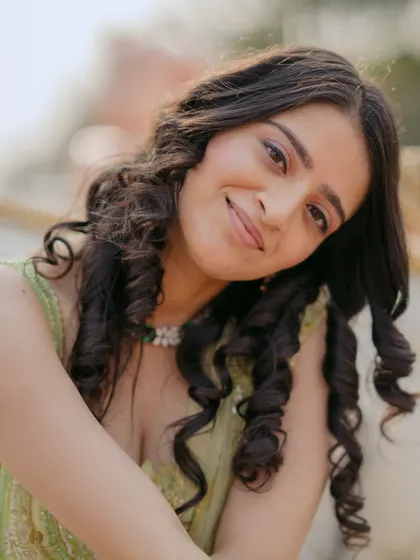 A charming close-up portrait of the bride-to-be, her head tilted with a sweet smile. This shot captures her natural beauty and happiness.