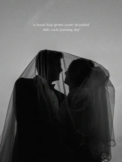 An intimate silhouette of the bride and groom beneath a delicate veil. This fine-art portrait captures the quiet promise and deep connection between two souls, a bond that grows more beautiful with each passing day.
