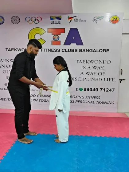Tying a yellow belt.
