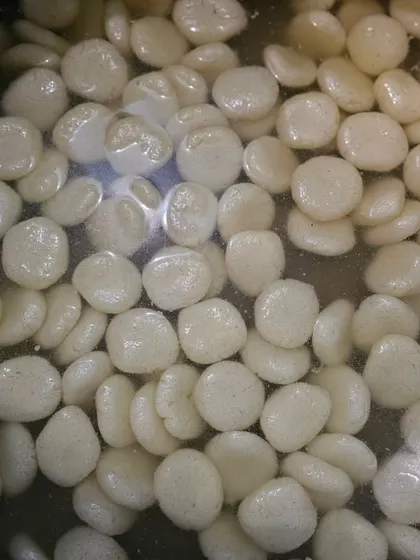 A bowl of soft and spongy Rasgullas, a popular Bengali sweet we offer for dessert.