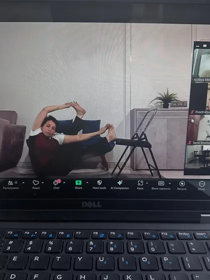 This student is using a chair to deepen her stretch in our online class. It's all about using what you have to support your practice.