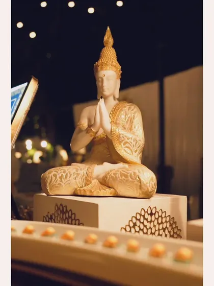 A serene Buddha statue as part of the decor for a Pan-Asian themed food station, helping to create an immersive culinary atmosphere.