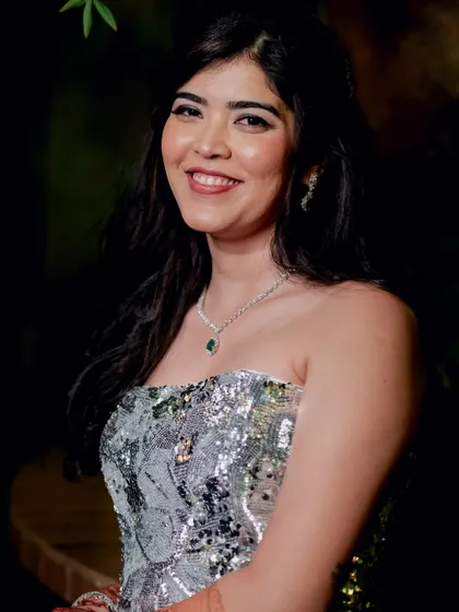 A smiling shot of Reeya at her cocktail party. Her snatched and sharp makeup look exudes confidence and glamour.