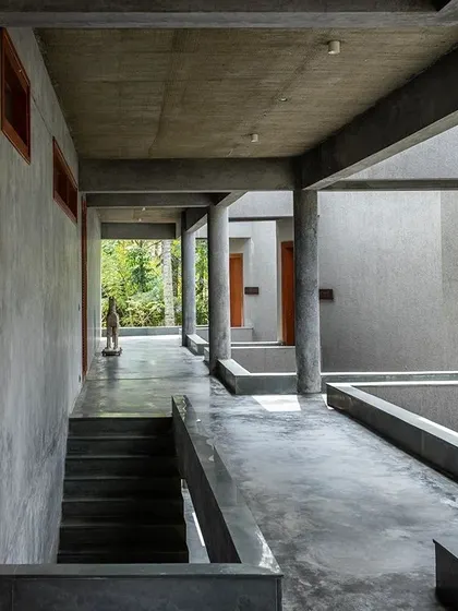 The stark materiality of the concrete at Anahaspa is softened by the lush green views at the end of each corridor, drawing the eye and connecting the user to the landscape.