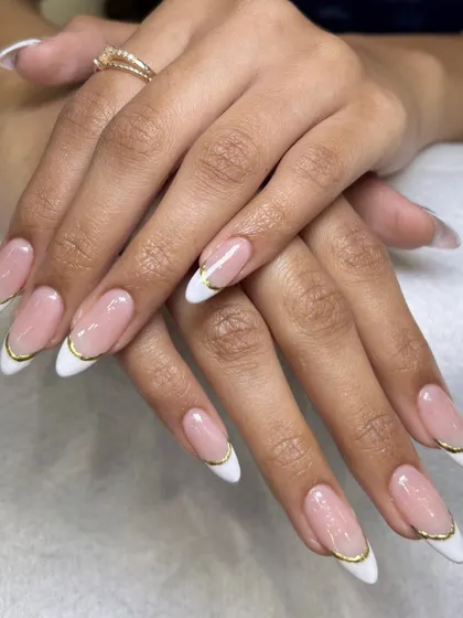You can never go wrong with a classic French manicure, but I love adding a little twist. This elegant look features a delicate gold chrome line along the tip for a modern and sophisticated finish on these almond-shaped nail extensions.