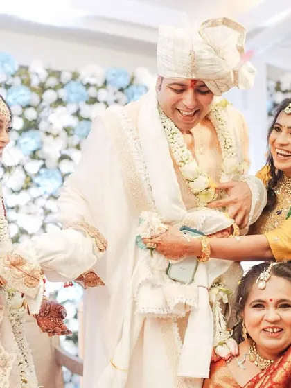 The playful ritual of 'joota chupai' or a similar tradition, where the bride's side playfully interacts with the groom.