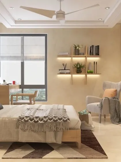 The same bedroom from a different angle, showing the TV unit and a comfortable reading chair.