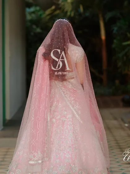 A personalized veil is a beautiful modern touch. This bride's veil was customized with the couple's initials and wedding date, adding a unique and sentimental detail to her look.