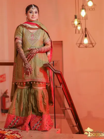 Another full-length portrait of the bride, showing her complete Mehndi look.
