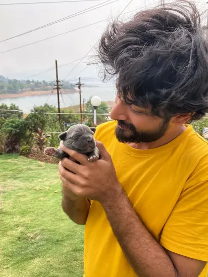 Another angle from my time with the newborn puppy, showing a moment of pure fascination and happiness.