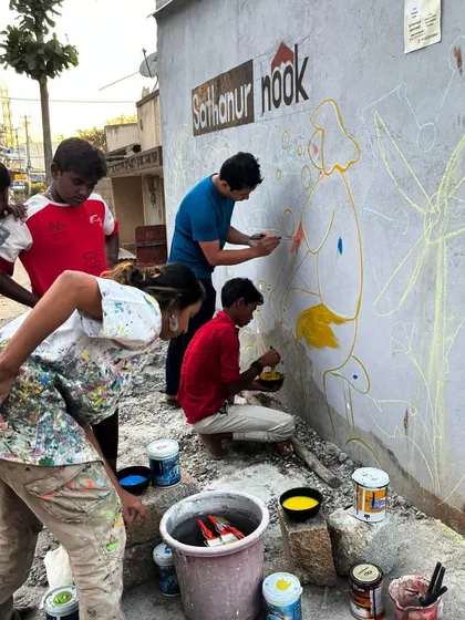 Another shot of me painting alongside the community members. This is collaboration in its purest form.