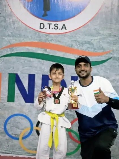A thumbs-up for this champion. His hard work in training really showed during the competition, earning him a well-deserved medal.