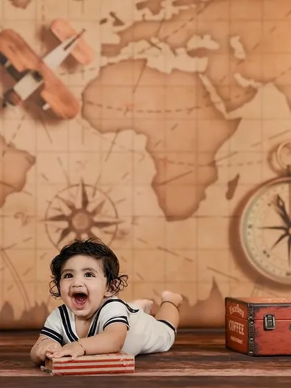 Ready for a world tour! Our travel-themed setup with a vintage map, globe, and suitcases is perfect for your little adventurer.
