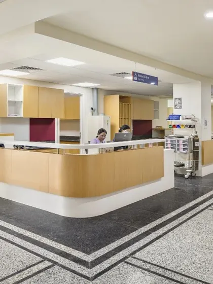 The reception and administrative hub in this hospital is designed for functionality. The curved wooden desks and clear pathways ensure smooth workflow for staff, while the open design keeps them connected to the main hospital corridors.