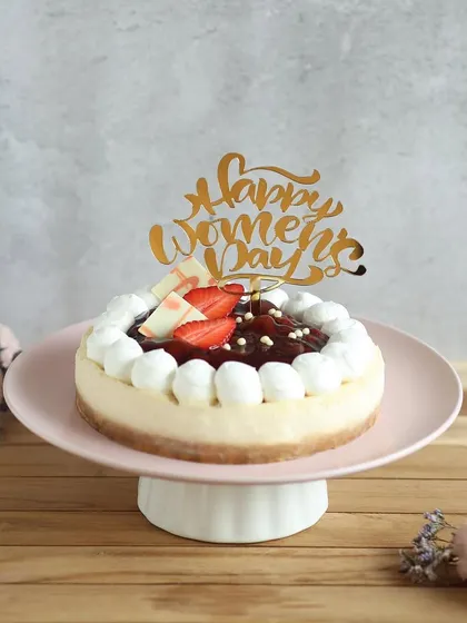 Our baked cheesecake topped with strawberry compote and a "Happy Women's Day" topper is an elegant and delicious way to celebrate.