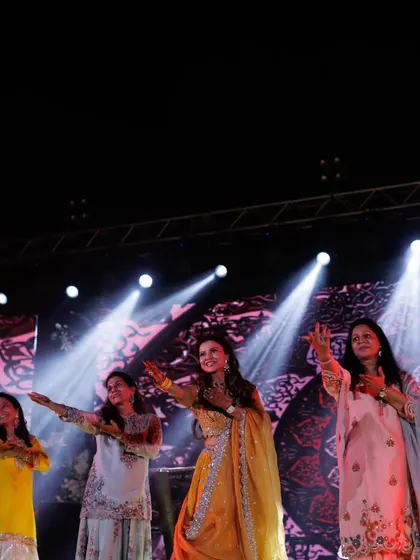 The ladies of the family performing at the Mehendi. The colorful outfits and joyful expressions are perfect.