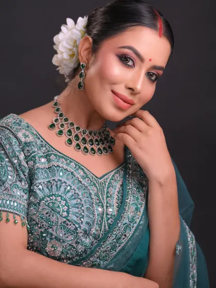 Another pose from the same set, showing the intricate embroidery on the blouse and how the makeup complements it.