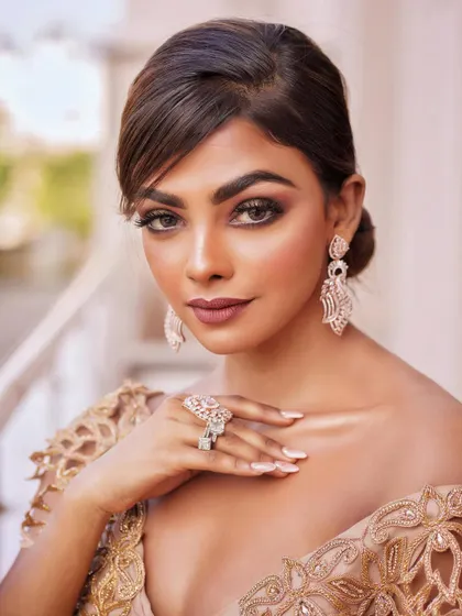 A stunning close-up portrait. The perfectly blended smokey eye and matte lip create a powerful and alluring look.