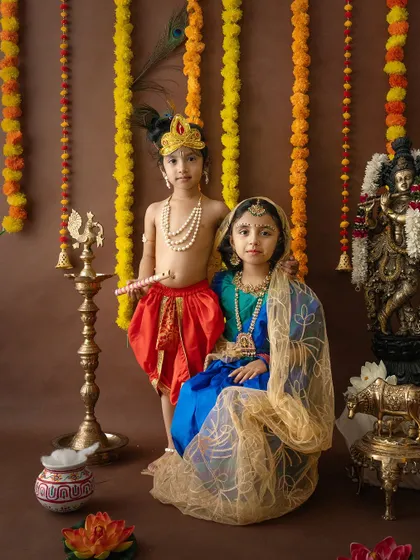 A lovely portrait of siblings dressed as Radha and Krishna for a Janmashtami photoshoot. This is a wonderful way to celebrate the festival and create lasting memories.