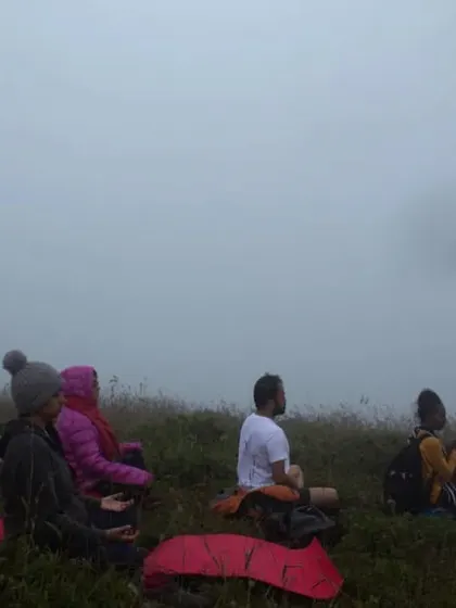 A group of participants practicing yoga on a viewpoint during our Silent Trek. Combining nature, silence, and yoga creates a powerful space for introspection and connection.
