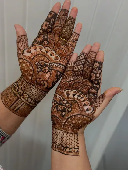 A lovely example of student work, showing great control over line thickness and pattern flow. The way the design wraps around the wrist is a technique we practice for a complete, professional look.