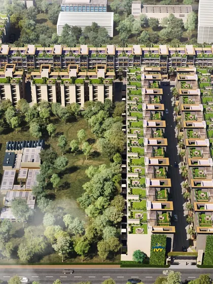 A bird's-eye view of a dense, green residential complex. This image highlights the use of rooftop gardens and lush corridors between buildings, emphasizing a commitment to sustainable design.
