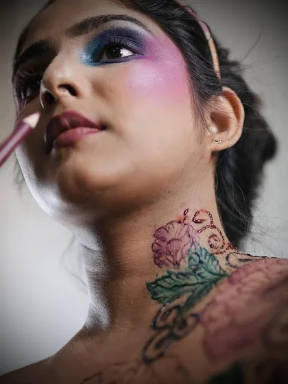 Another angle of the vibrant floral henna tattoo on the neck and shoulder, demonstrating how it can be a beautiful accessory for an artistic look.