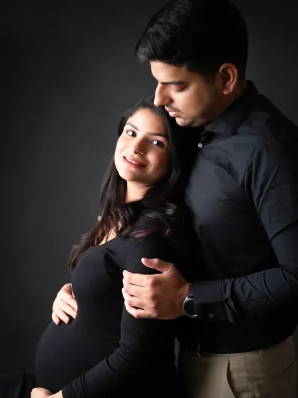 A beautiful and intimate couple's portrait. The soft lighting and their close embrace create a romantic and heartfelt mood.