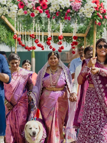 A closer look at the grand entrance, showing the family's cherished pet walking right alongside them. It highlights how important it is to include all family members in your big day.