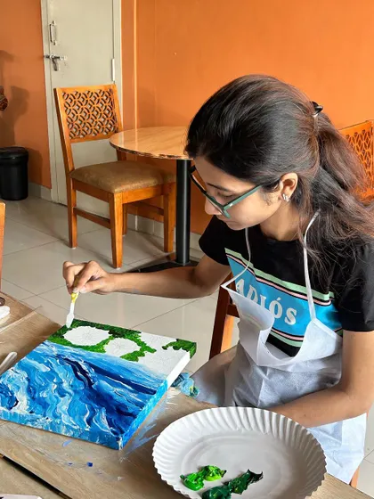A participant adding details to her sunflower painting. The workshop is suitable for all skill levels.