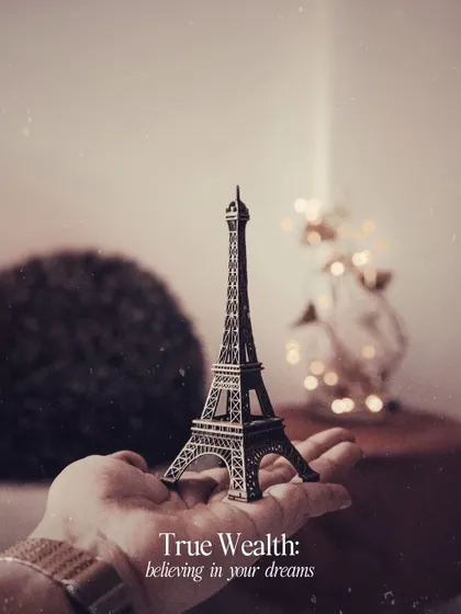 A miniature Eiffel Tower held in hand, a symbol of believing in your dreams. This kind of conceptual flatlay allows me to tell a story or convey an idea in a single frame.