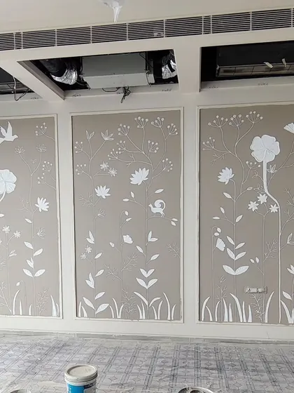A work-in-progress shot of a 3D texture mural being created on three separate wall panels. This technique allows for a clean, framed look.
