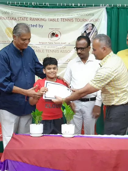 One of our young champions is awarded his certificate at the state ranking tournament. His smile reflects the joy of achievement that comes from disciplined practice and competitive play.