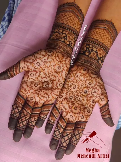 A truly unique engagement mehendi where the names of beloved family members are written inside small circular patterns, making the design a tribute to her loved ones.