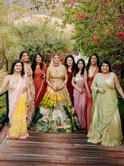 The bride with her bridesmaids, a beautiful portrait showcasing the coordinated colors and the supportive bond of friendship.