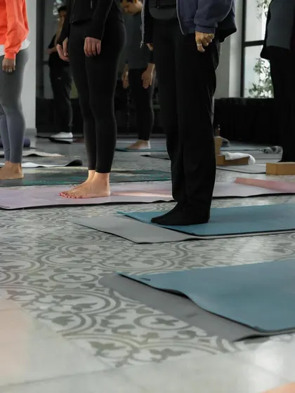 The foundation of our practice begins with our connection to the earth. Here, students are grounding through their feet in preparation for standing postures, a key element of Vinyasa Krama.