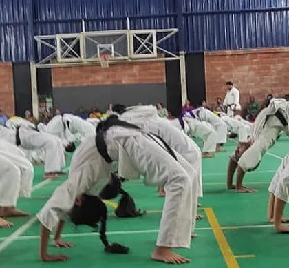 Students performing a back bridge stretch during a conditioning session. Flexibility is a key component of our training program to prevent injuries and improve technique.