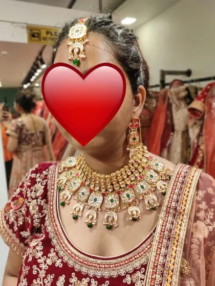 Another in-store trial. This client is trying on a beautiful multi-colored Kundan set to see how it pairs with her outfit.