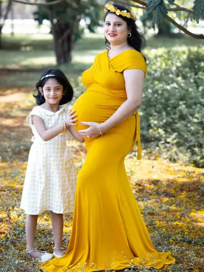 A beautiful moment between a mother-to-be and her daughter, who gently holds her mom's baby bump. It's so special to include older siblings in maternity sessions.