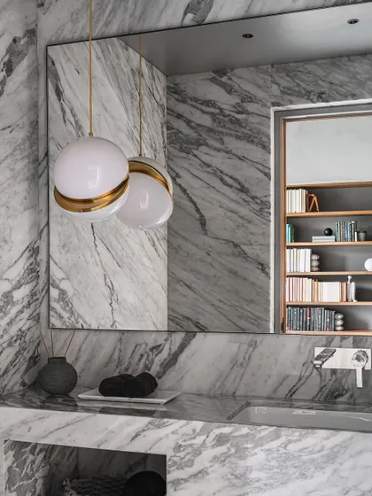The study bathroom in the Vaulted Haus is finished entirely in Statuario marble. The custom vanity and sink are carved from the same material, creating a seamless, monolithic space.
