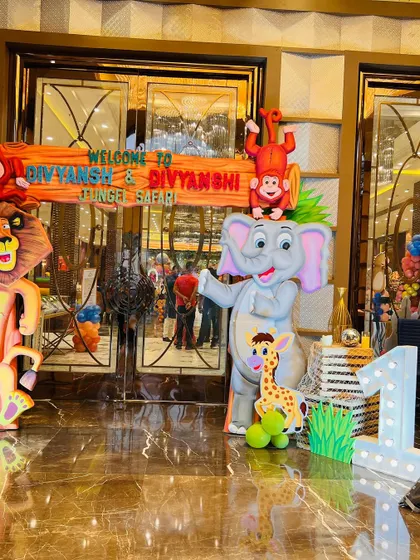 The entrance to the jungle safari party, guarded by friendly lion and elephant character cutouts.