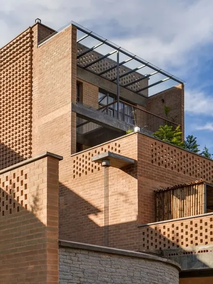 The architecture of the Sunyata Hotel features a play of open terraces and built mass, with flat roofs used for rainwater harvesting and private viewing decks.