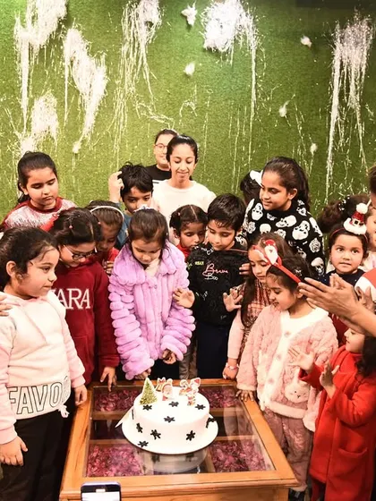 A sweet moment as our students gather around the cake during our Christmas party. It's all about making magical memories together.