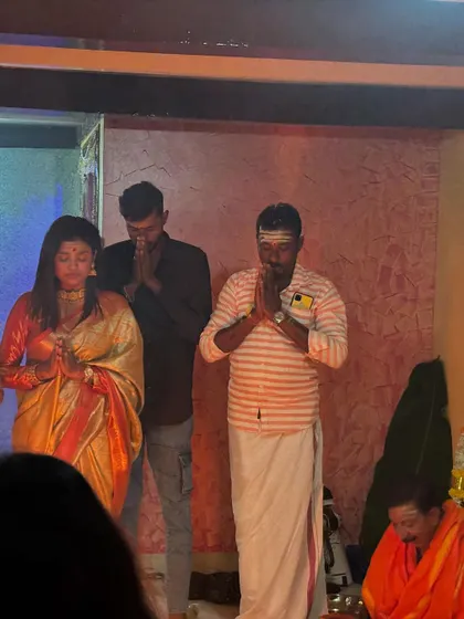 Sonu during the housewarming puja, looking serene and traditional.