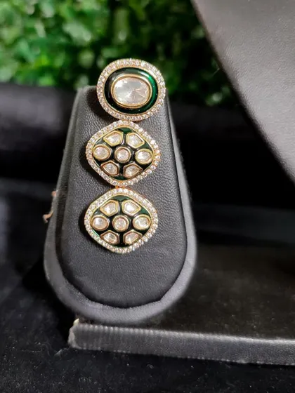 A modern earring with black enamel and polki stones. This rental piece is part of a set but makes a bold statement by itself.