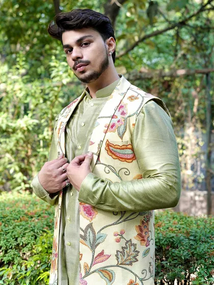 A confident pose in our floral Nehru jacket and green kurta set. This outfit is perfect for a man who wants to embrace color and pattern in a sophisticated way.
