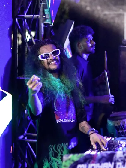 A happy, candid moment during a show, where I am smiling and pointing at the crowd.