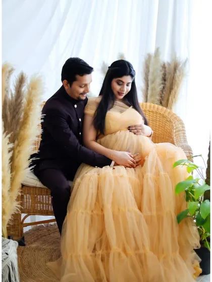 A tender moment shared between a couple in our boho-themed studio setup. The warm lighting and natural elements create a serene and romantic atmosphere.